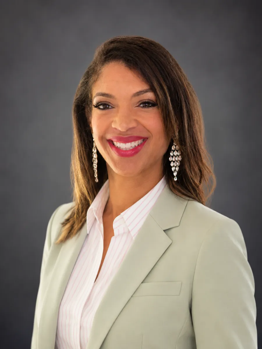Professional headshot of Teah Floyd, MBA, founder of Next Level Professional Property Management Group, smiling in a light green blazer.